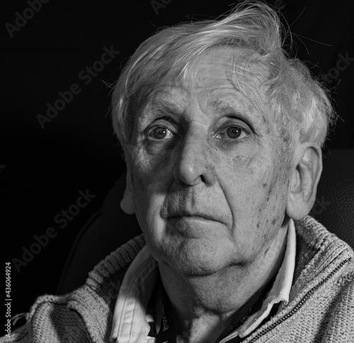Old man looking upwards and thinking