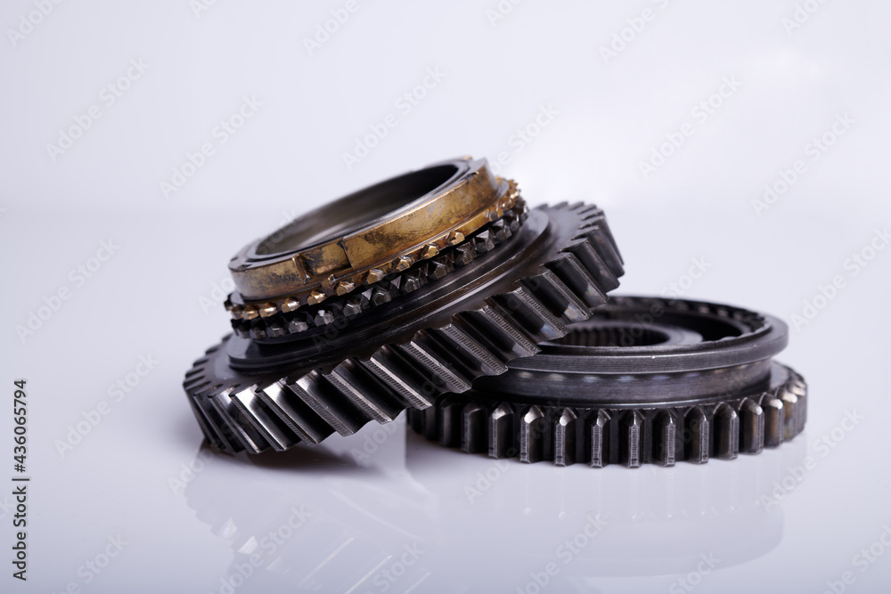 Parts on a gray background. Gears of gear shifting torque transmission. Old gear box parts. Parts on a gray background. Gears of gear shifting torque transmission. Old gear box parts.