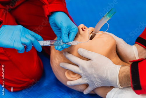 Medical manipulation for airway management. Laryngeal mask airway insertion by stuff in a blue gloves on a simulation mannequin dummy during medical training. ACLS. Close up