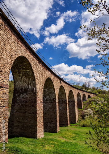 Old railway stone viaduct in the spring in sunny day. photo