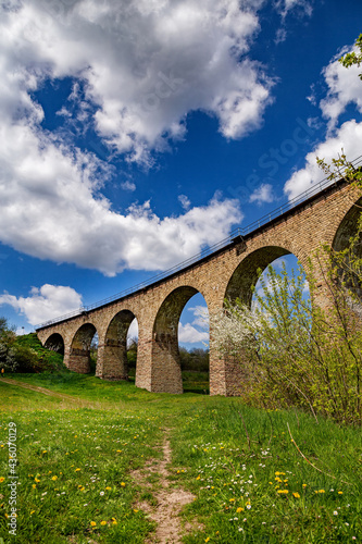 Old railway stone viaduct in the spring in sunny day. photo