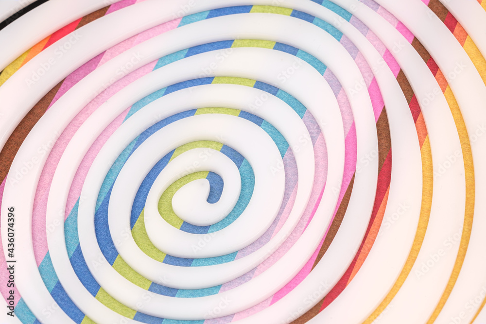 Simple white spiral on Multicolored paper background Simple white spiral on Multicolored paper background