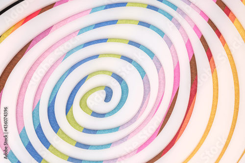 Simple white spiral on Multicolored paper background