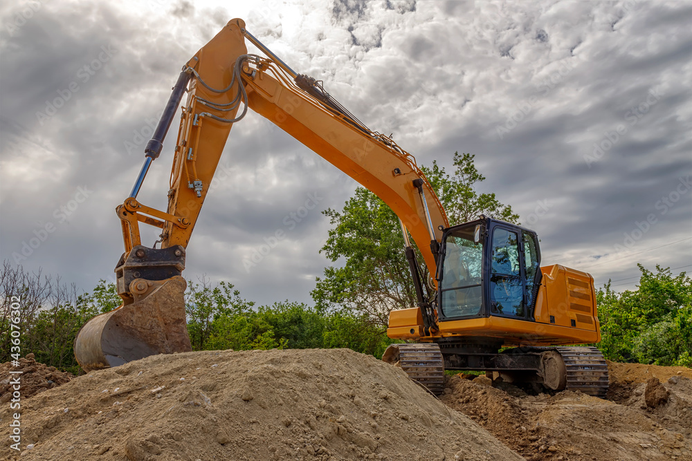 Break, big excavator with a shovel at the construction site. Horizontal view Break, big excavator with a shovel at the construction site. Horizontal view