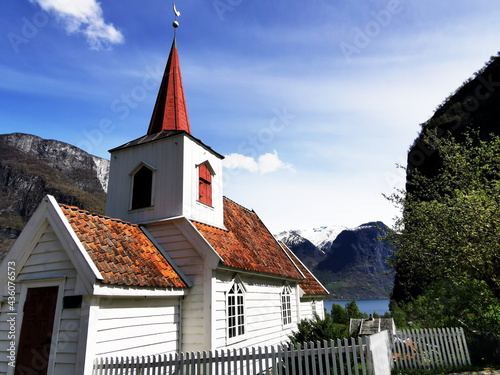 Beautiful wooden church, also known as a Stave church, in Norway, surrounded by mountains photo