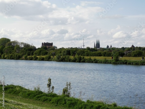 Bremen-Neustadt, Germany - May 16 2021: Lake Werdersee in sunny spring weather. Sights in background: Dom, Umgedrehte Kommode, Television tower Walle. Rowing boat track in foreground.