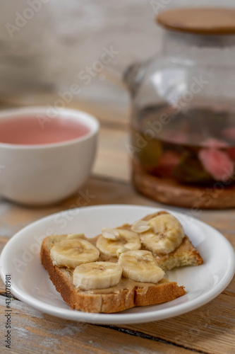 Homemade peanut butter  sandwich with bananas on wooden background