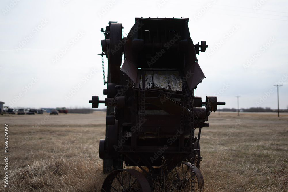 Naklejka premium combine harvester working on a field