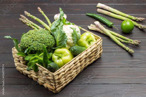 Set of green vegetables in rattan basket