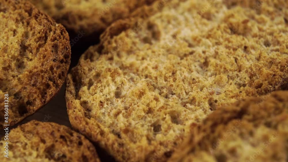 A bunch of baked rusks. Macro shot. Rotating textured slices with crust A bunch of baked rusks. Macro shot. Rotating textured slices with crust