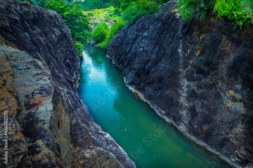 River Water flowing between rock with nature background.