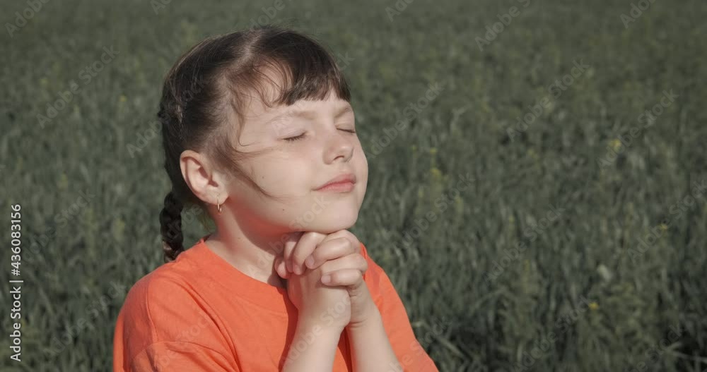 The kid is praying. Adorable little girl prays in nature. The kid is praying. Adorable little girl prays in nature.