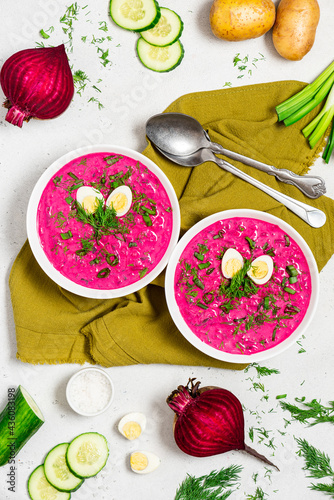 Chłodnik (Šaltibarščiai) - traditional east european soup. Cold summer soup of beets, kefir, cucumbers, eggs and dill in a white bowl top view. Summer food, Eastern European cuisine.