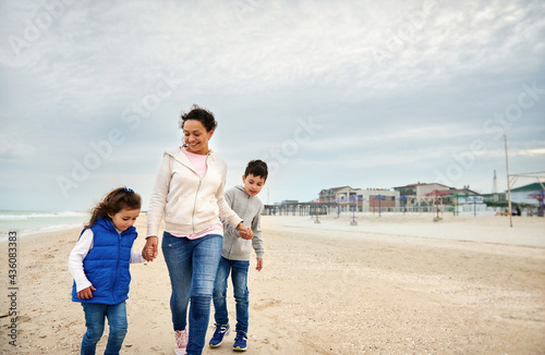 Happy mother with her children walking on the beach. Happy family concept. Happy motherhood concept. Happy mother's Day