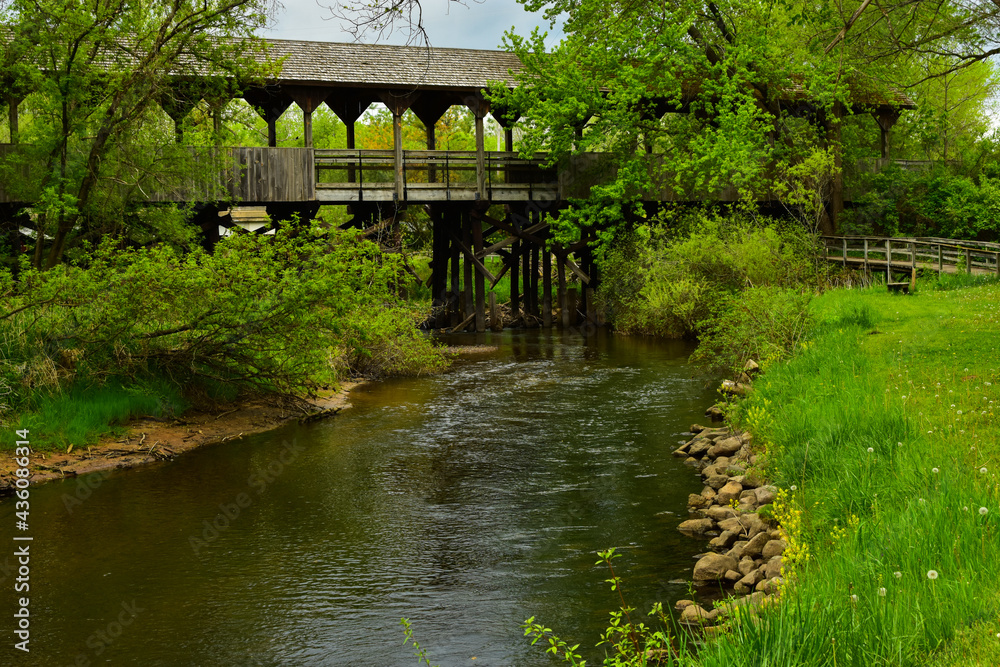 Bridge Reed Green Covered wooden foot bridge over small peaceful creek in Reed City ...