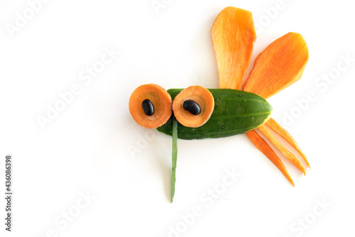 Food art creative concepts. Funny mosquito fly made of fruits and vegetables, such as carrots and cucumber isolated on a white background.