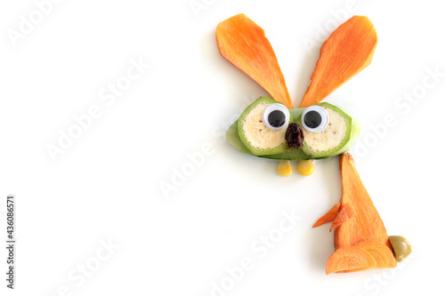 Food art creative concepts. Funny bunny rabbit made of fruits and vegetables, such as carrots and cucumber isolated on a white background.