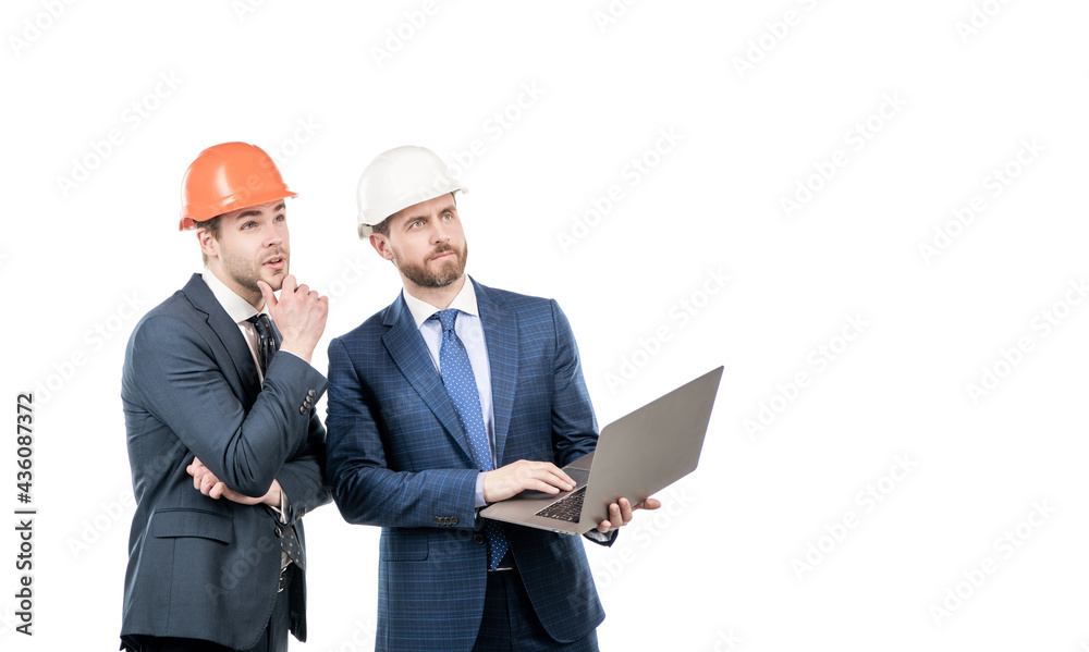 businessmen in helmet with laptop. architects planning work. chief engineer and executive in hardhat businessmen in helmet with laptop. architects planning work. chief engineer and executive in hardhat
