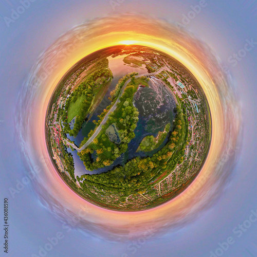 Spherical 360 degrees panorama of sunrise over landscape with fields and green grass. Little planet panorama