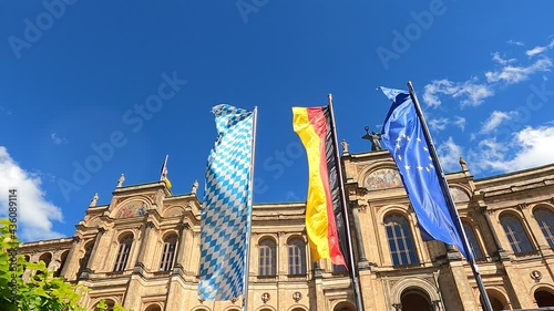 Bavarian, German and European Union flags flying in the wind in front of the Maximilianeum / Bavarian State Parliament building in Munich, Germany photo