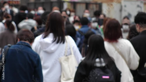 Wallpaper Mural OSAKA, JAPAN - APRIL 2021 : Crowd of people wearing surgical masks to protect from Coronavirus (COVID-19) at the street in busy rush hour. View of commuters after work around Osaka train station. Torontodigital.ca