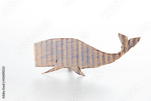 Cute whale made of cardboard on a white background. Children art project. DIY concept. Cardboard craft.