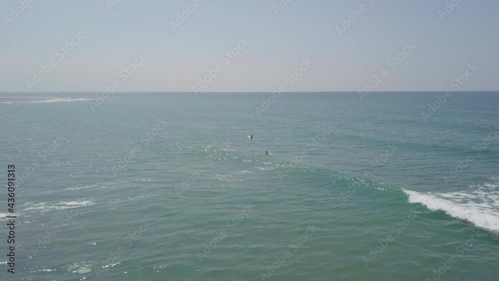 Aerial Forward Shot Of Friends Surfing In Sea On Sunny Day, Drone Flying Against Clear Sky During Vacation - Zambales, Philippines 