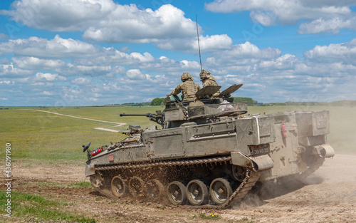 british army FV510 Warrior light infantry fighting vehicle tank in action on a military battle exercise, Wiltshire UK
