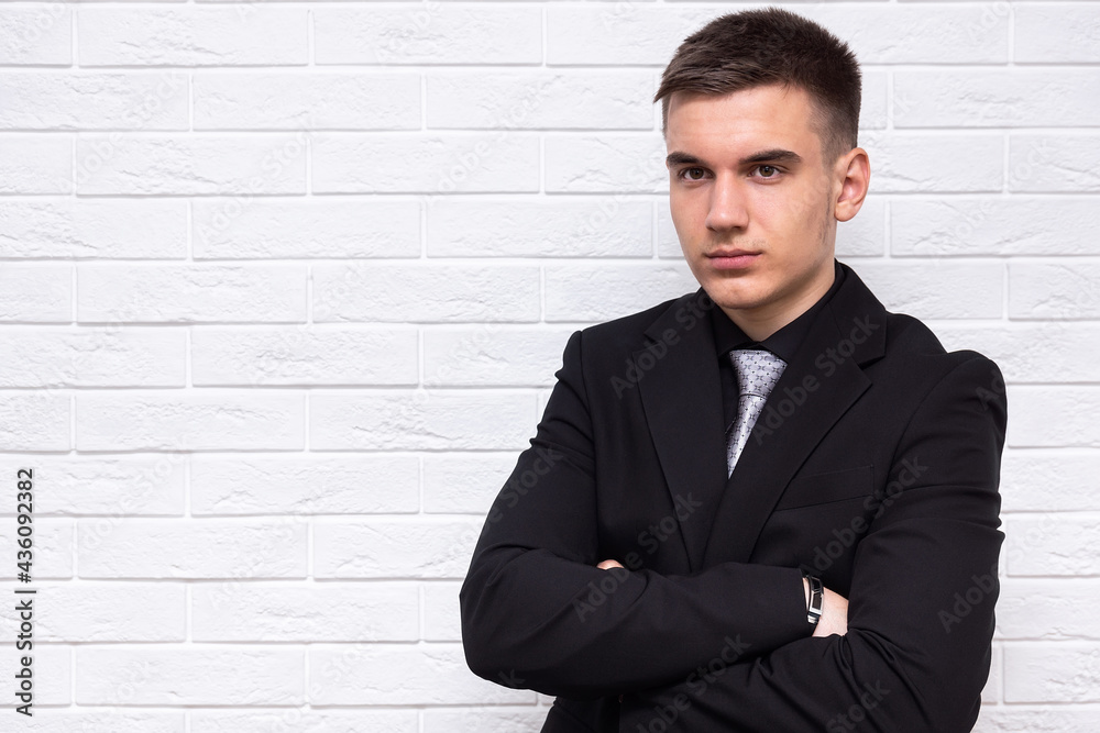 Male businessman on a white brick wall background Male businessman on a white brick wall background