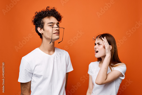 cheerful young couple in white t-shirts wearing glasses emotions