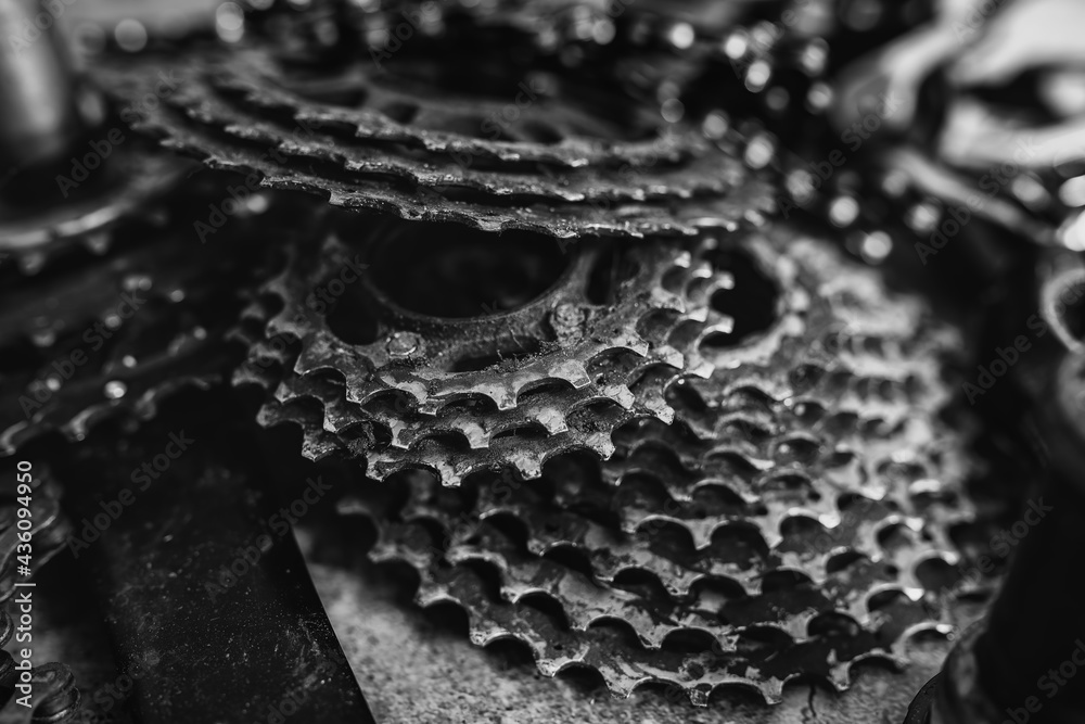 Worn mountain bike components - chain rings and cassettes.