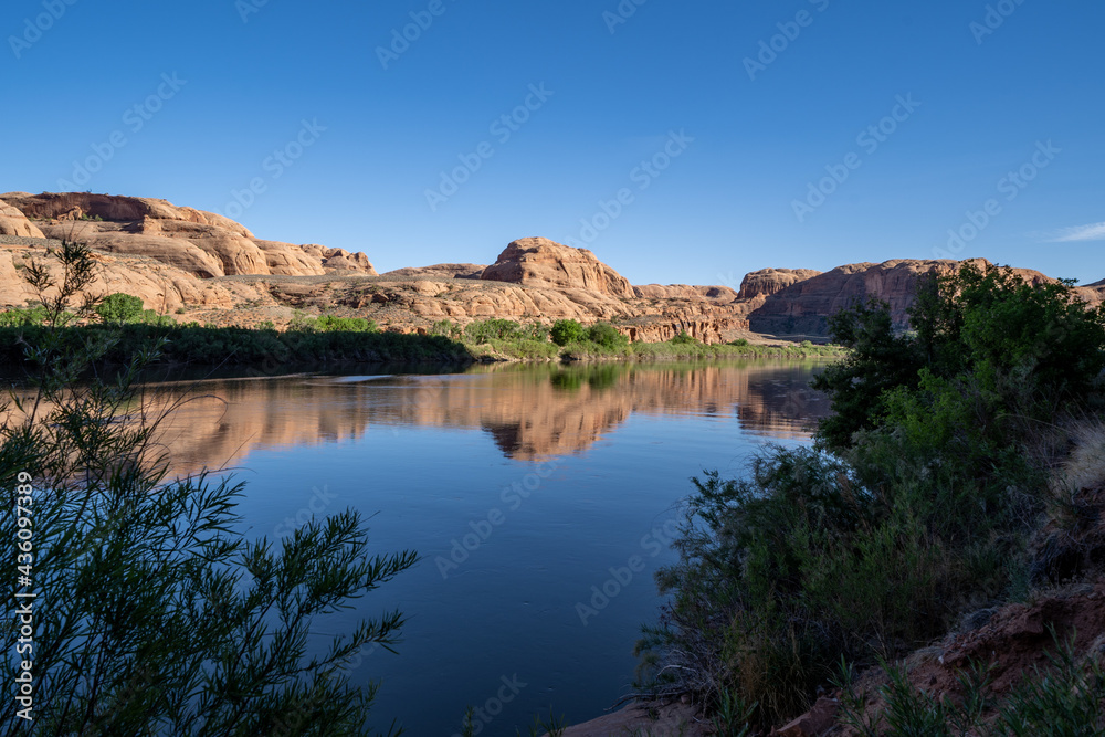 Calm Colorado River in Moab, along Potash Road in the late afternoon sunshine