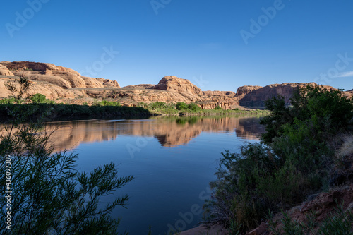 Calm Colorado River in Moab, along Potash Road in the late afternoon sunshine