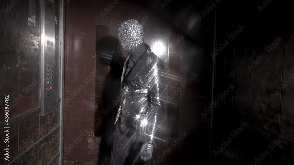 Sparkle masked man enters a lift Sparkle masked man enters a lift