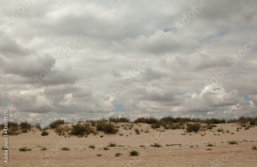 Sand dunes and cloudy sky