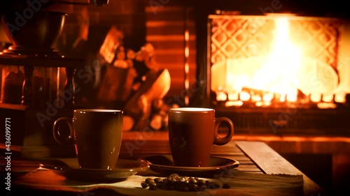 A burning fireplace with a cup of steaming coffee. Cozy home mood.	