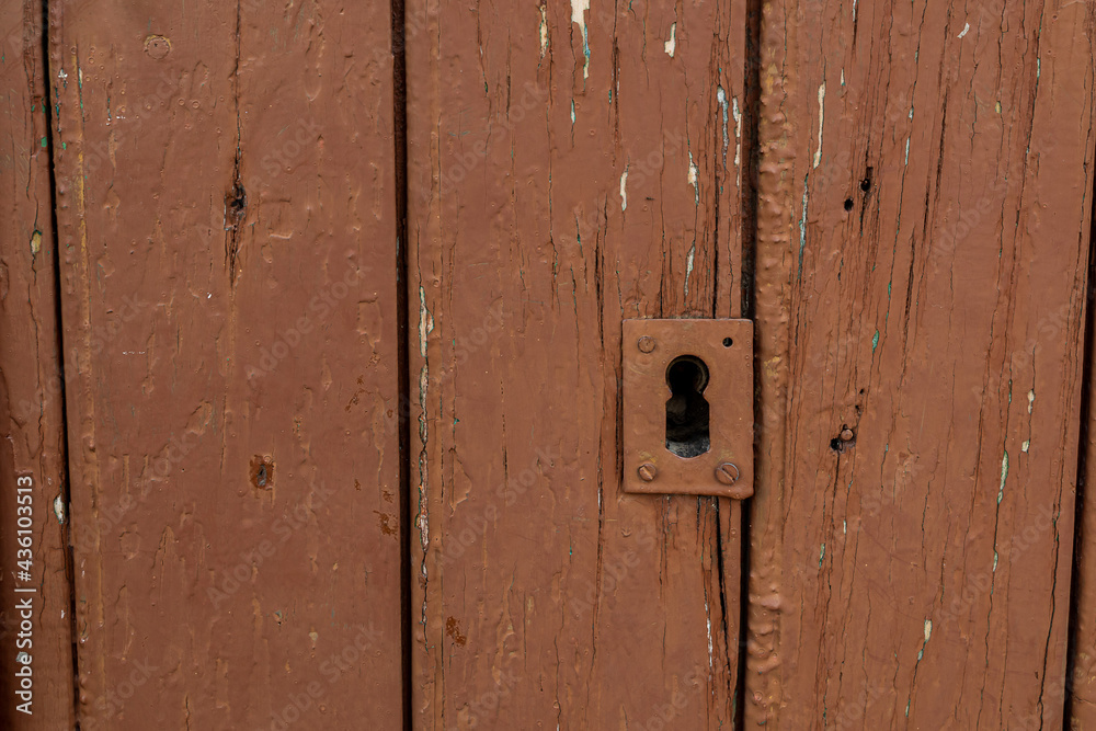  old vintage brown wooden door with keyhole