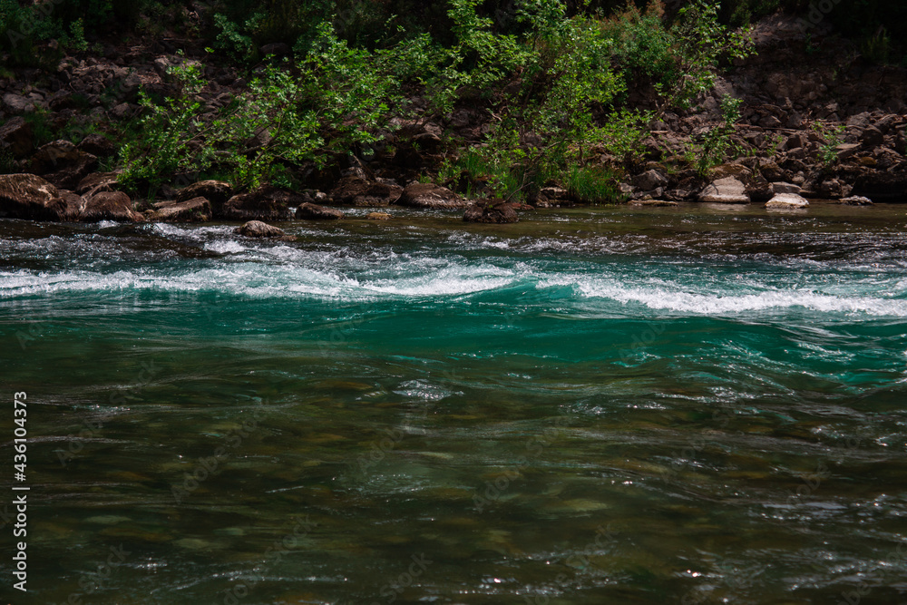Fast river with rapids high in the mountains Fast river with rapids high in the mountains