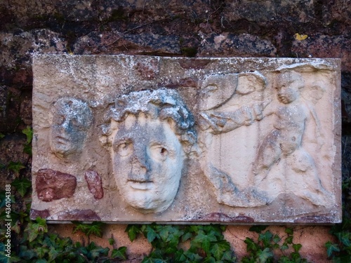 Small Roman relief with a face and a child on a wall in Vitchen, Luxembourg photo