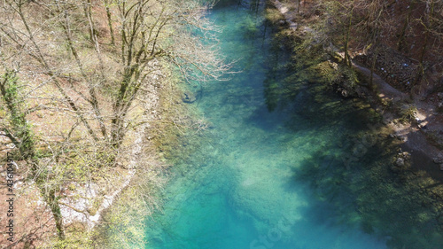 Aerial view of blue and green water colour of mountain river Kupa spring, deep in the rocky mountains of Risnjak, national park in Croatia