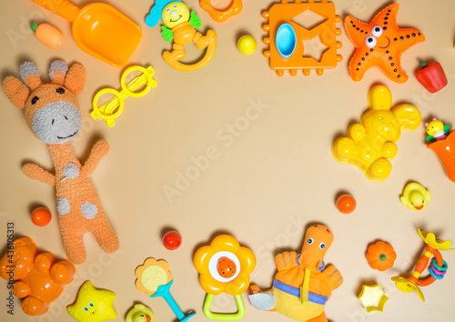 Children's children's toys frame. A set of colorful orange toys on an orange background. Top view, flat layout