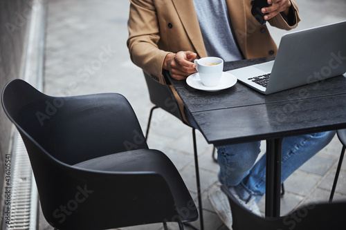 Close up of freelancer sitting in cafe