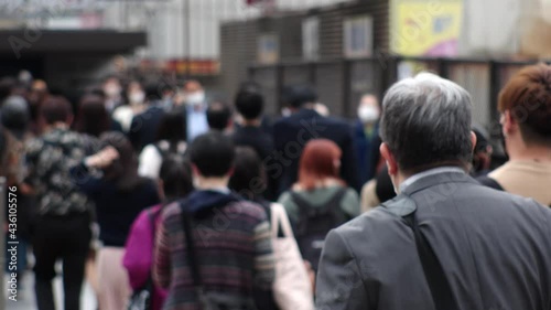 Wallpaper Mural OSAKA, JAPAN - APRIL 2021 : Back shot and unidentified crowd of people wearing surgical masks to protect from Coronavirus (COVID-19) at the street. Slow motion shot. In front focus. Torontodigital.ca