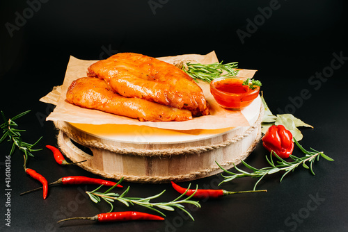 Marinated Chicken Breast with spices and rosemary. Raw meat in the marinade. Sottilissime raw fillet with spices and rosemary for grilling top view. photo