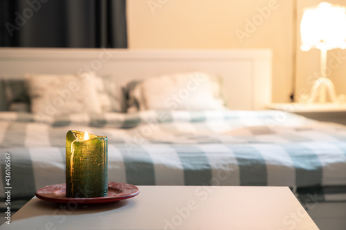 cozy bedroom detail focus on burning candle