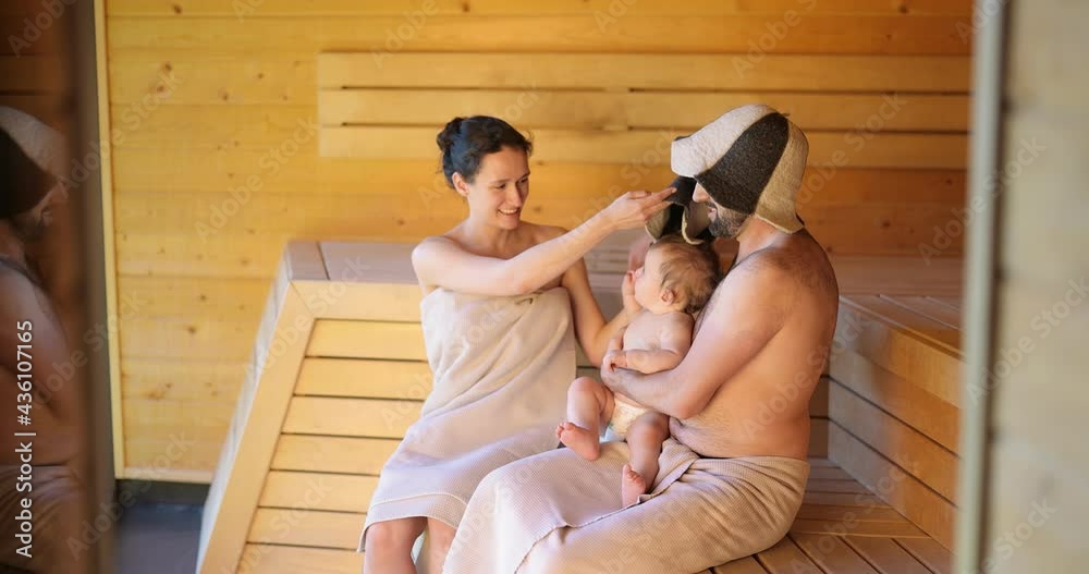Young family resting with a little baby boy in sauna. Family vacation with one year child in spa vídeo de Stock | Adobe Stock