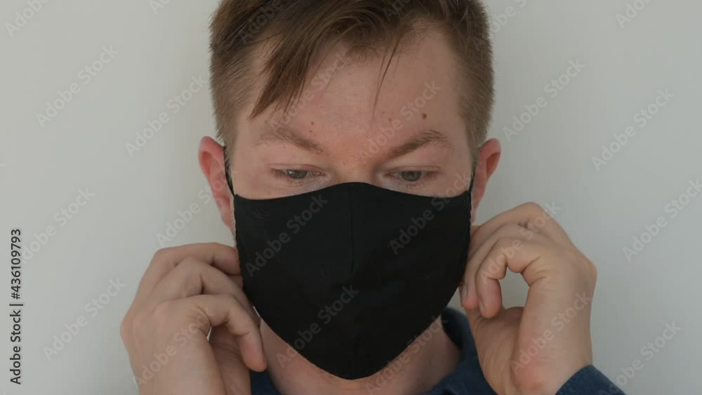 Portrait of man putting face mask on Portrait of man putting face mask on