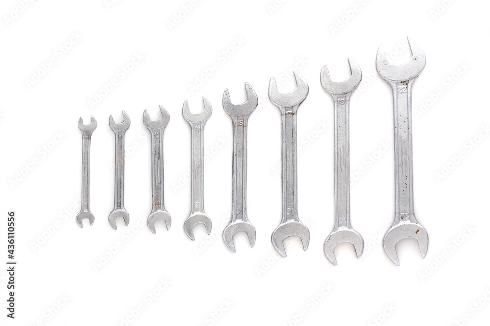 Set of wrenches different size on white background with copy space, text place. Banner with instruments kit for repair car. Business card for tools shop. Close up. Size line. Flat lay. Layout. Mockup. Set of wrenches different size on white background with copy space, text place. Banner with instruments kit for repair car. Business card for tools shop. Close up. Size line. Flat lay. Layout. Mockup.