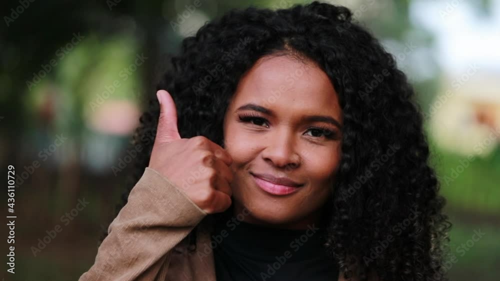 Brazilian girl gives thumb up, positive confirmation. happy client Brazilian girl gives thumb up, positive confirmation. happy client