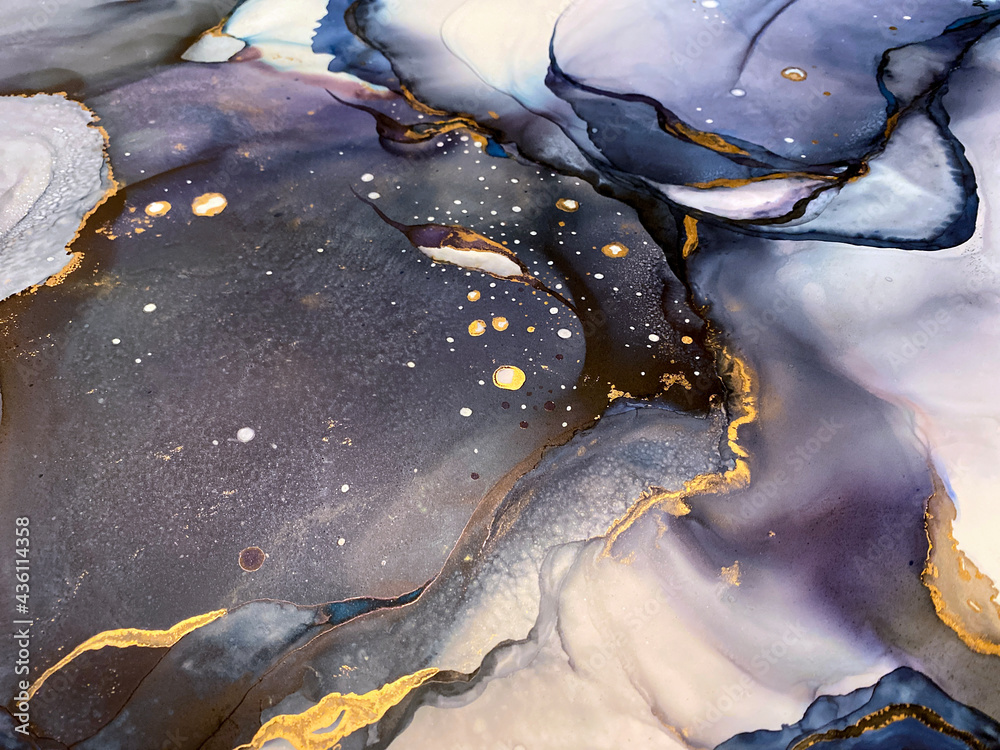 Abstract purple art with gold — violet and blue background with beautiful smudges and stains made with alcohol ink and golden pigment. Lilac fluid art texture resembles watercolor or aquarelle.